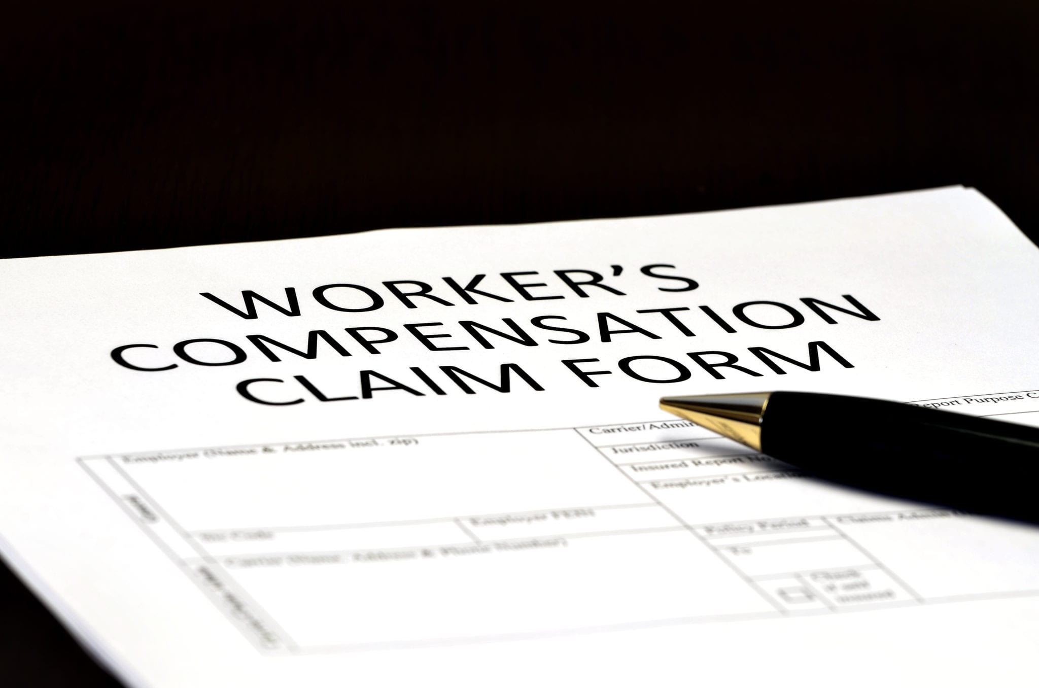 Close up of Worker's Compensation Claim form and black pen